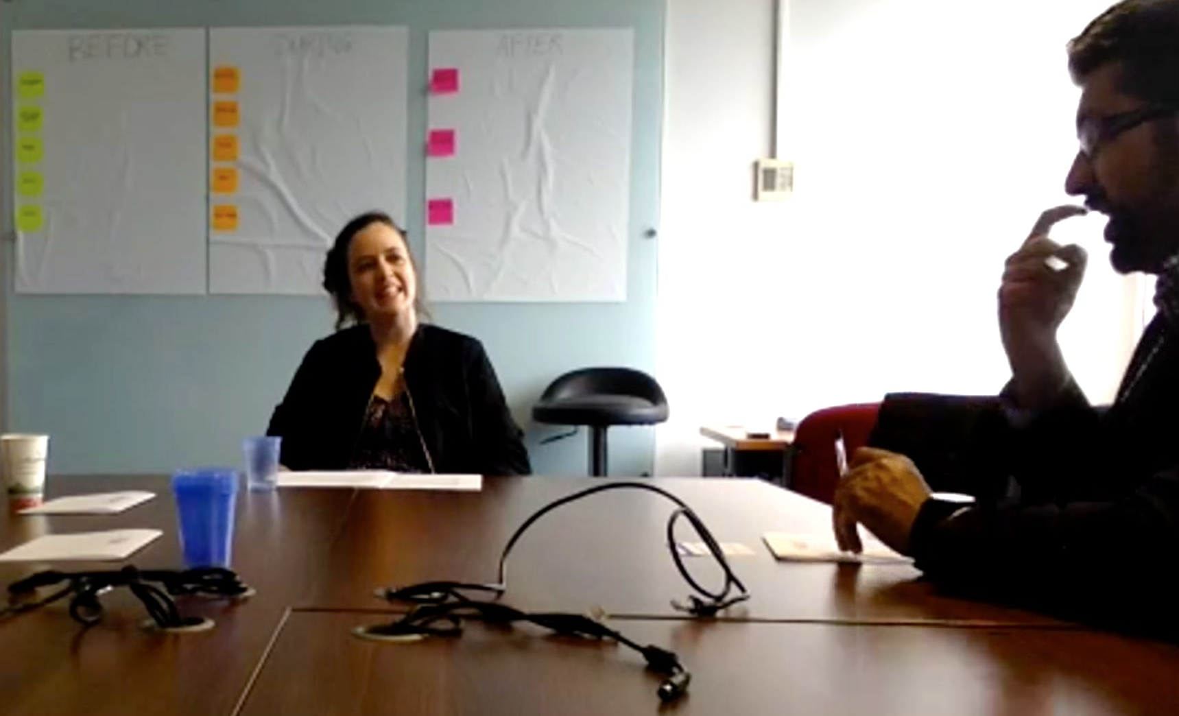 A focus group in progress, with before / during / after boards of sticky notes on the wall behind